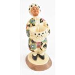 CLARICE CLIFF; an unusual figural candlestick, height 14.5cm.Condition Report: The figure has been