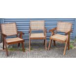 A pair of contemporary hardwood elbow chairs with cane work back and seats, and a similar slightly