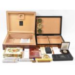 Two humidors, a quantity of cigars and a boxed Dunhill cigar cutter.