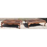 A pair of reproduction mahogany coffee tables with glass tops, width 135cm, depth 85cm.