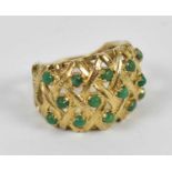 A 9ct yellow gold dress ring set with fourteen small green stones, size M, approx 6.8g.