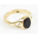 A 9ct yellow gold signet ring set with central black plaque, size M, approx 2.7g.