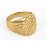 A yellow metal gents ring, stamped 18k size V, approx 12.6g.