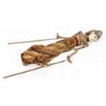 A vintage Indonesian stick puppet with overall painted decoration, length approx 65cm.
