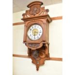 A Victorian carved walnut wall clock with brass and silvered dial, approx 85cm.