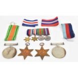 A group of four World War II medals and miniature including The Defence Medal, The France and