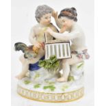 MEISSEN; a porcelain figure group depicting two boys forcing a cockerel into a cage, height 14cm.