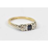 An 18ct yellow gold lady's dress ring set with central sapphire and two white stones, size P/Q,