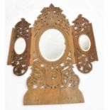 A carved and pierced olivewood triptych folding mirror, height 46cm.