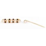 A 9ct gold stick pin set with a pearl, 1.3g, also a yellow metal brooch (2).