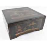 An early 20th century black lacquer and chinoiserie decorated box, 38 x 38cm.