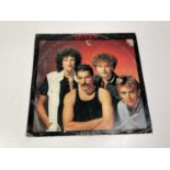 QUEEN; Radio Ga Ga, a record with sleeve bearing the four signatures of the band members and