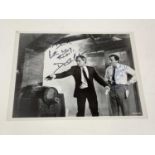 THE MAN FROM UNCLE; a black and white action photograph bearing signatures of David McCallum and