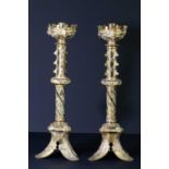 A pair of decorative brass altar style candlesticks with relief decoration, height 43cm. Condition