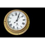SMITHS; a brass cased ships' clock, the enamelled dial set with Arabic and Roman numerals and signed