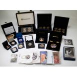 A collection of British commemorative coins and medallions to include a cased set of six at the