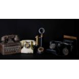 A collection of assorted vintage telephones to include a black metal painted candlestick example,