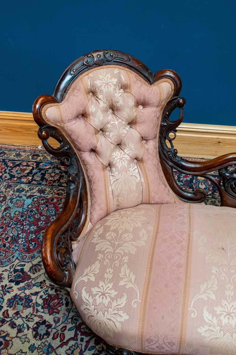 A Victorian carved walnut framed settee with scrolling back, upholstered in a salmon pink and floral - Image 3 of 4
