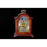 HERMLE; a reproduction mahogany effect bracket clock, the silvered and brass coloured face set