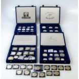 Four coin boxes containing various British and foreign coinage including Elizabeth II millennium