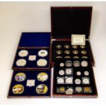 Four wooden coin cases containing various British and foreign coins including The Royal Baby