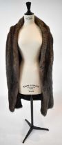 A brown full length fur coat, size 38.