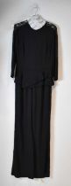 ELIE SAAB; a black jumpsuit with black lace trim, size 38. Condition Report: One sleeve slightly