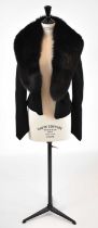 GIVENCHY; a black wool short fitted jacket with detachable fur trim, size small.