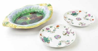 A Victorian majolica bread plate of shaped oval form with moulded decoration, length 36cm, and two