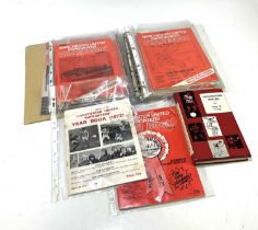 MANCHESTER UNITED; an album containing various year books including 1977-78 signed, 1987-88, various