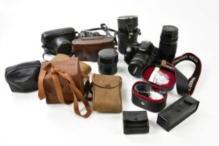 A quantity of cameras to include a Canon EOS 450D, with two lenses, a collection of 35mm and further
