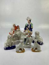 A small group of Staffordshire figures to include spaniels, 'The Lion Slayer', man on horseback,