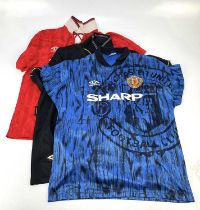 MANCHESTER UNITED; three vintage replica football shirts including Umbro 1992/93 home and away