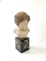 AUGUSTE-HENRI CARLI; a French ceramic bust of a boy on a marble plinth, impressed signature and