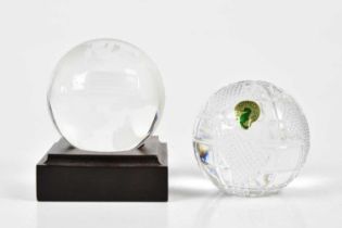 WATERFORD; a paperweight modelled as the globe, and a further etched globe glass paperweight for the