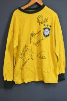 BRAZIL; a 1970s retro-style football shirt, signed to the front by Pele, Jairzinho, Carlos