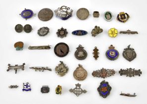 A collection of assorted badges and medallions including hallmarked silver example Justice Truth