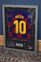 LIONEL MESSI; a signed Barcelona football shirt, 67 x 87cm, framed and glazed. Condition Report: