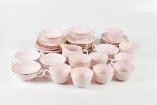 MINTON; a part tea service with ribbed decoration on a pink ground.