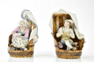 A pair of late 19th century Continental painted bisque figures representing a seated male and