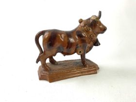 An unusual treacle glazed ceramic model of a bull, indistinctly stamped, length 24cm.