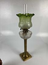 A Victorian oil lamp with green and frosted glass shade with floral decoration, the cut glass