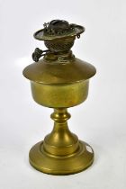 Two brass oil lamps, one with glass fount and clear glass chimney, both lacking shade, height of