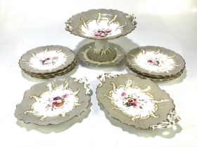 A hand painted and gilt part tea service to include nine plates, two serving plates and a comport.