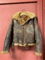 A vintage sheepskin flying jacket. Condition Report: Unusual wear and scuffs/losses to colour.