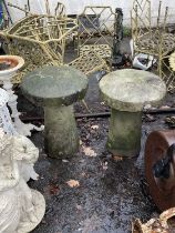 A near pair of stone staddle stones, with circular caps, height 72cm.