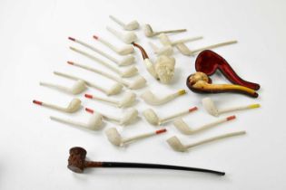 Two vintage Meerschaum pipes, with a collection of clay pipes, and a Black Forest type pipe.