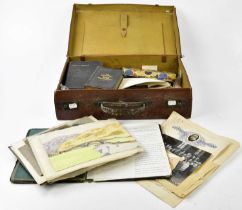 A collection of ephemera contained in a suitcase including Boy Scouts Association badge, various