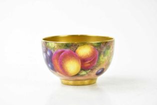 FREEMAN FOR ROYAL WORCESTER; a hand painted footed bowl decorated with fruit and gilt interior,