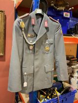 A reproduction German Army jacket, with badges and patches.